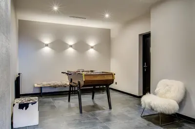 a room with a piano and two chairs at The Drus Luxury Apartment with Spa and Indoor Pool in Chamonix-Mont-Blanc