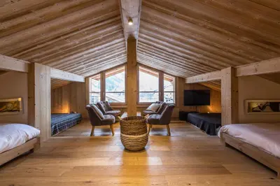 a large room with two beds and a tv at Chalet Yolo - Chalet Retreat in Central Chamonix Steam Room in Chamonix-Mont-Blanc