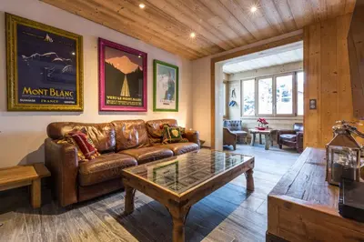 a living room with a leather couch and a coffee table at Chalet Yolo - Chalet Retreat in Central Chamonix Steam Room in Chamonix-Mont-Blanc