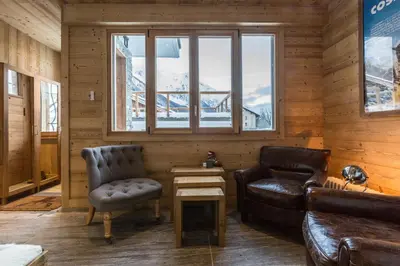 a living room with a couch and a chair at Chalet Yolo - Chalet Retreat in Central Chamonix Steam Room in Chamonix-Mont-Blanc