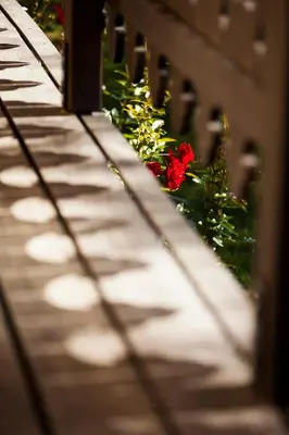 a wooden bridge with a red flower on it at Chalet Yolo - Chalet Retreat in Central Chamonix Steam Room in Chamonix-Mont-Blanc