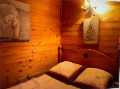 a room with a bed in a wooden room at Appartement l'Edelweiss in Megève