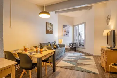 a living room with a table and a couch at Apartment Lognan 6 Centre Chamonix Mont Blanc in Chamonix-Mont-Blanc
