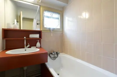 a bathroom with a sink and a bath tub at Apartment Lognan 6 Centre Chamonix Mont Blanc in Chamonix-Mont-Blanc