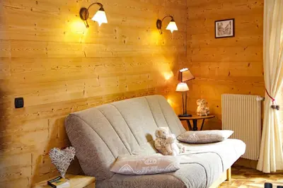 a teddy bear sitting on a couch in a room at Maison Salina in Samoëns