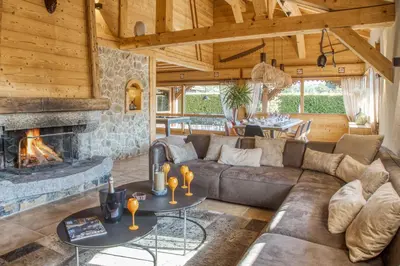 a living room with a couch and a fireplace at Le CHALAY in Les Carroz d'Araches