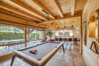 a large room with a pool table in a house at Le CHALAY in Les Carroz d'Araches