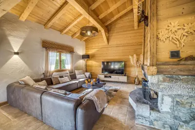 a living room with a couch and a fireplace at Le CHALAY in Les Carroz d'Araches