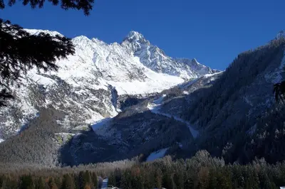 a snow covered mountain with a lake in a valley at Appartement Capucine in Chamonix-Mont-Blanc