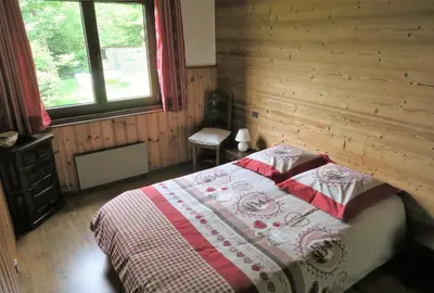 a bedroom with a bed in a wooden cabin at Appartement Capucine in Chamonix-Mont-Blanc