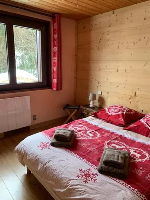 a bedroom with a bed with two towels on it at Appartement Capucine in Chamonix-Mont-Blanc