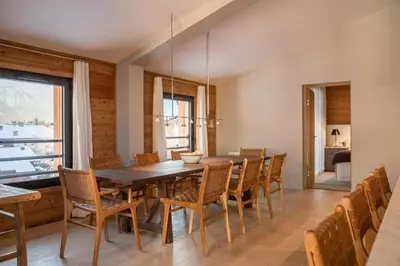 a dining room with a wooden table and chairs at La Cordee 331 Apartment in Chamonix-Mont-Blanc