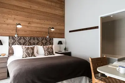 a bedroom with a bed and a table and a desk at La Cordee 331 Apartment in Chamonix-Mont-Blanc