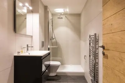 a bathroom with a sink and a toilet and a shower at La Cordee 331 Apartment in Chamonix-Mont-Blanc