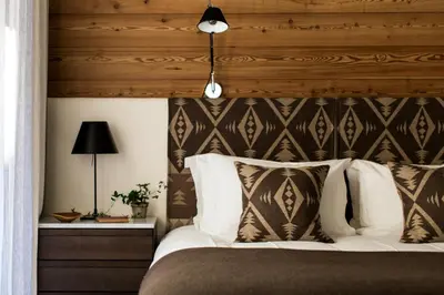 a bedroom with a bed with a wooden headboard at La Cordee 331 Apartment in Chamonix-Mont-Blanc