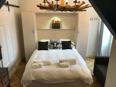 a bedroom with a large white bed with pillows at Marie Paradis Studio Apt 15 in Chamonix-Mont-Blanc