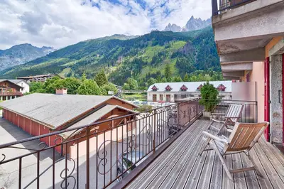 a balcony with chairs and a view of mountains at Marie Paradis Studio Apt 15 in Chamonix-Mont-Blanc