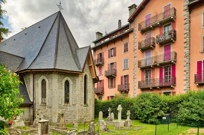 a church in a cemetery next to a building at Marie Paradis Studio Apt 15 in Chamonix-Mont-Blanc