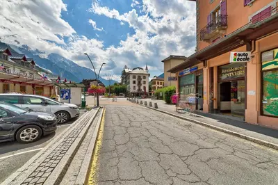 a street in a town with cars parked on the road at Marie Paradis Studio Apt 15 in Chamonix-Mont-Blanc