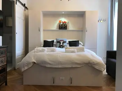 a bedroom with a large white bed in a room at Marie Paradis Studio Apt 15 in Chamonix-Mont-Blanc