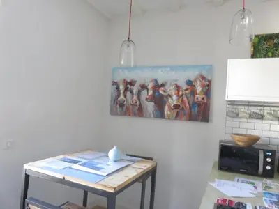 a kitchen with a table and a painting on the wall at Marie Paradis Studio Apt 15 in Chamonix-Mont-Blanc