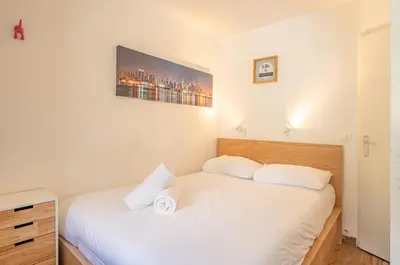 a bedroom with two beds with white sheets at Apartment Grepon 3A - A Central Chamonix Haven in Chamonix-Mont-Blanc