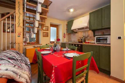 a kitchen with a table with a red table cloth at Appartement Beauregard 1 - Happy Rentals in Les Houches