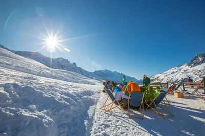 a group of people sitting in chairs in the snow at Appartement Beauregard 1 - Happy Rentals in Les Houches