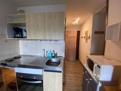 a small kitchen with a sink and a microwave at Les Cimes in Samoëns