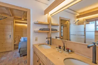 a bathroom with a sink and a mirror at Chalet Les Meuniers in Megève