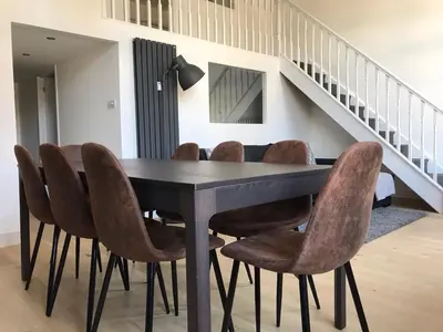 a dining room with a black table and brown chairs at Le Mont Joly in Saint-Gervais-les-Bains