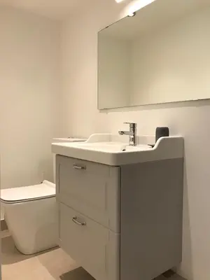 a bathroom with a sink and a toilet and a mirror at Le Mont Joly in Saint-Gervais-les-Bains