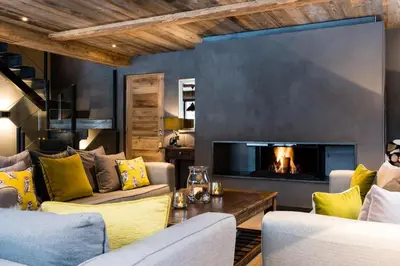 a living room with two couches and a fireplace at Chalet Seren in Chamonix-Mont-Blanc