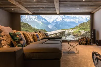a living room with a large window with a mountain view at Chalet Seren in Chamonix-Mont-Blanc