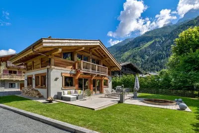 a house in the mountains with a yard at Chalet Seren in Chamonix-Mont-Blanc