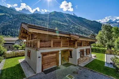 a house with a mountain in the background at Chalet Seren in Chamonix-Mont-Blanc