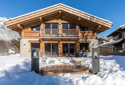 a log home in the snow with a fire pit at Chalet Seren in Chamonix-Mont-Blanc