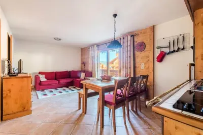 a living room with a red couch and a table at Appartement 3 pièces 6 pers proche pistes - maeva Home - 3 Pièces 6 Personnes Sélection MAE-4880 in Arâches-la-Frasse