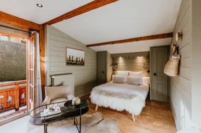 a bedroom with a bed and a table at Hôtel Restaurant La Ferme de Cupelin in Saint-Gervais-les-Bains