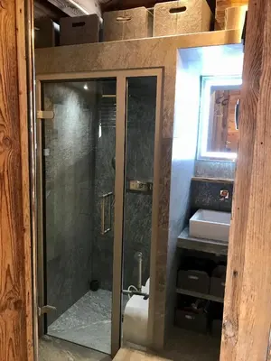 a glass shower in a bathroom with a sink at CHALET ALBA in Chamonix-Mont-Blanc