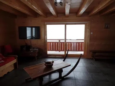 a woodburning fireplace in a cabin with a staircase at Le Caribou in Saint-Gervais-les-Bains