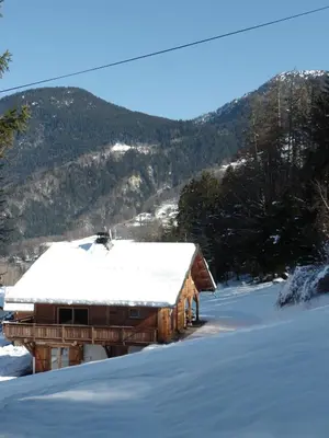 a snow covered cabin with a snow covered roof at Le Caribou in Saint-Gervais-les-Bains
