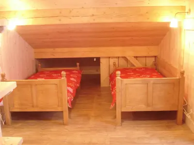 a living room with a wooden table and a large window at Le Caribou in Saint-Gervais-les-Bains