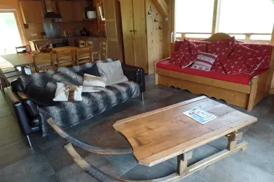 two beds in a small room with wooden walls at Le Caribou in Saint-Gervais-les-Bains