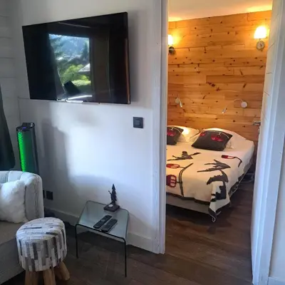 a bedroom with a bed in a wooden room at Les Fermes Mégevannes in Megève