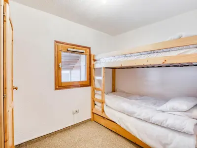 two bunk beds in a room with a mirror at Apartment La piste A by Interhome in Saint-Gervais-les-Bains