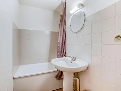 a bathroom with a sink and a bath tub at Apartment La piste A by Interhome in Saint-Gervais-les-Bains