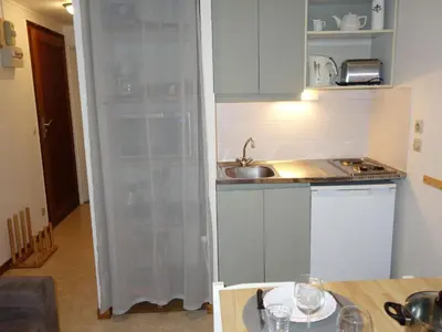 a living room with a wooden door and a table at Apartment La piste A by Interhome in Saint-Gervais-les-Bains