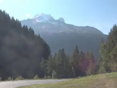 a road in the mountains with a snow covered mountain at Apartment Le Plan des Reines by Interhome in Chamonix-Mont-Blanc