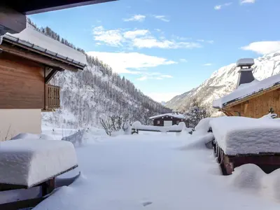 a yard covered in snow next to a house at Apartment Le Plan des Reines by Interhome in Chamonix-Mont-Blanc